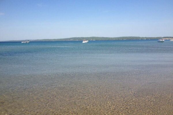 View of boats on Torch Lake from the beach.