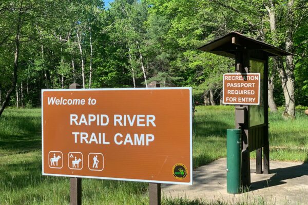 Sign welcoming hikers and riders to the Rapid River Trail Camp.