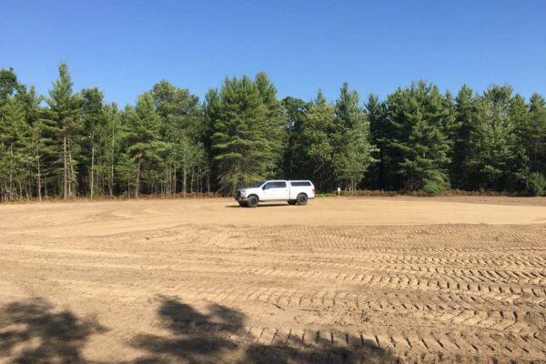 Great Lakes Land Co. company truck parked in the middle of a freshly cleared and graded parcel in the Silerado Estates residential property development.