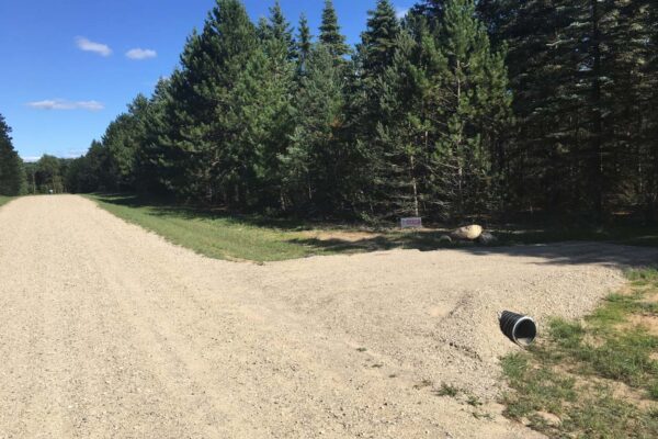 Dirt road with a gravel driveway.