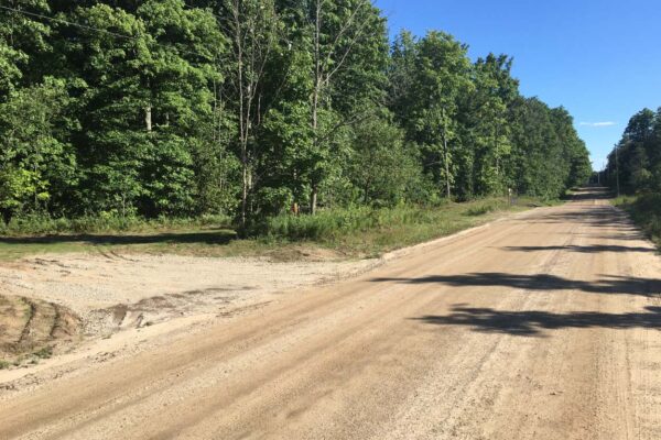Dirt road with a gravel driveway.
